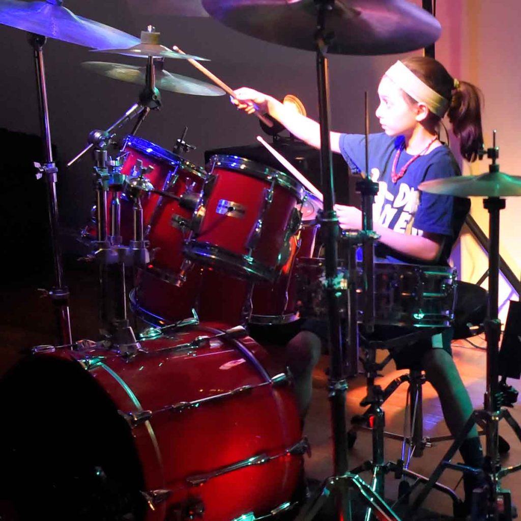 Young female taking drum lessons