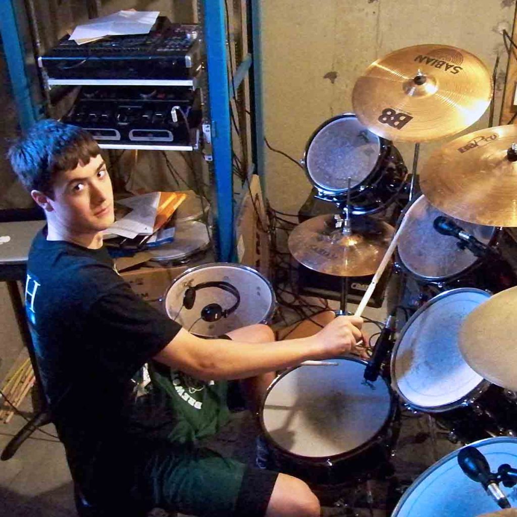 Teen male taking drum lesson